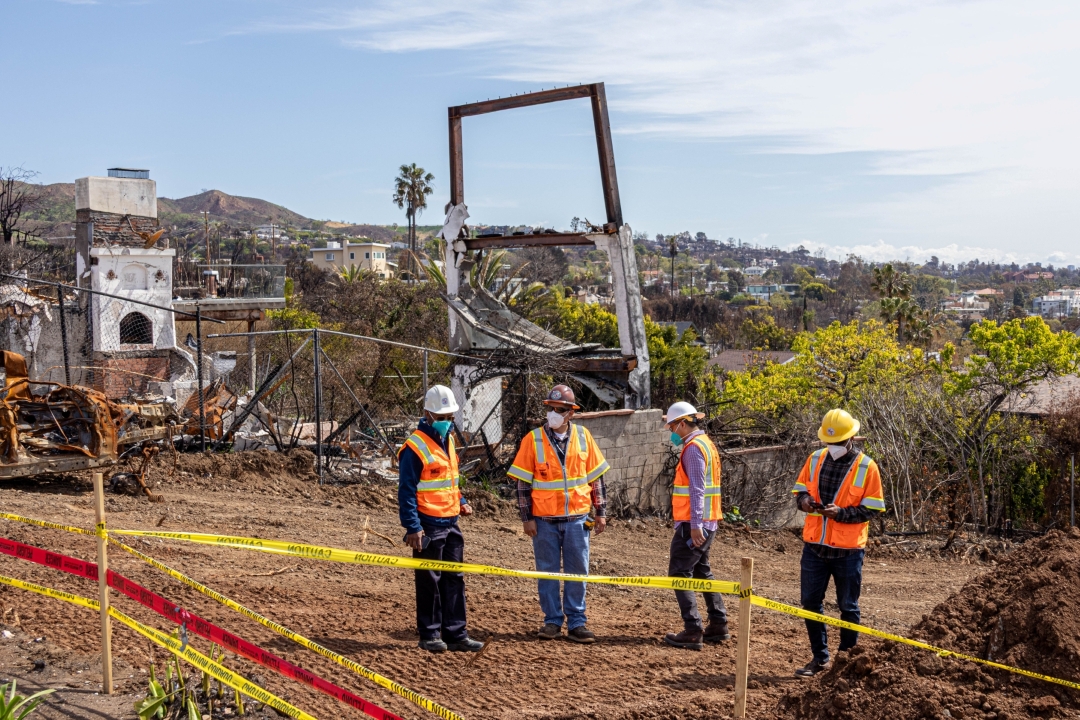 Construction workers reviewing plans for a site